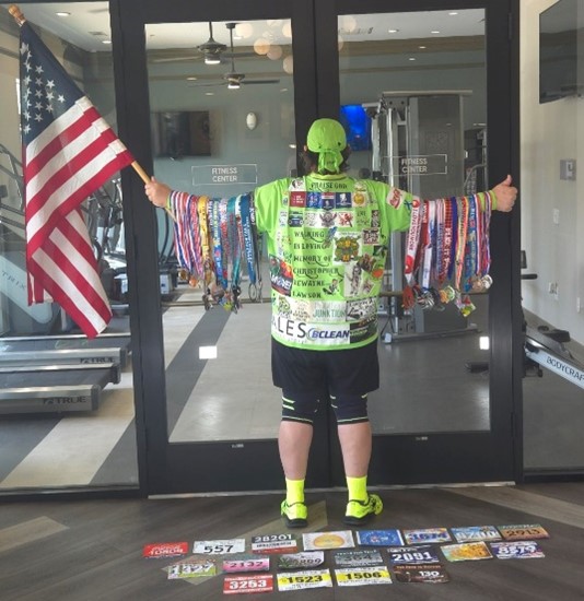Photo of Terry sporting his medals and holding an American flag